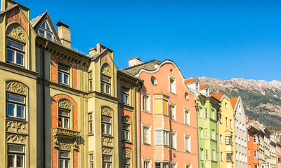 Fototapeta na wymiar The ornate and colourful residential buildings in the famous Mariahilf district of Innsbruck town, Inn riveside, Austria, Europe.