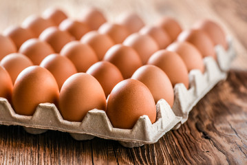 Brown Egg, Chicken eggs in caton on wooden table.