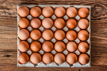 To view of eggs. Fresh Chicken brown eggs in box.  Egg on wood table.