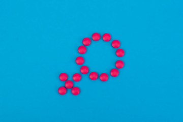 Venus mirror gender symbol made of pills or tablets. Medicine concept for woman. Women's health menopause, PMS, menstruation or estrogen.