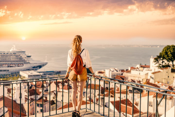 Traveller wearing a bag and white shirt exploring beautiful cityscape of Iberic country in Europe during summer sunset - obrazy, fototapety, plakaty