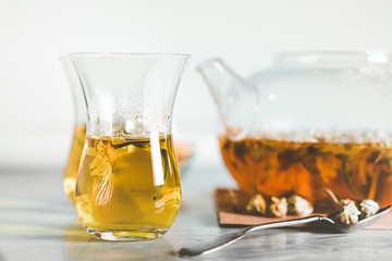  Cup and teapot filled with herbal tea