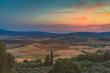 Beautiful sunset over the hills near Pienza. Travel destination Tuscany, Val d'Orcia, Italy