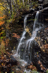 Fototapeta na wymiar Madonna peak Sterling Range stream waterfall from Smugglers Notch road Vermont in Fall