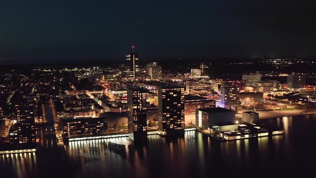 Aerial view of Almere city center with its modern architecture, illuminated in th evening. Suburban city near Amsterdam, The Netherlands.