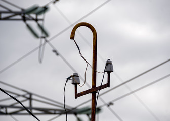 old electric pole on a background of a high voltage line