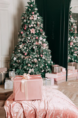 New Year's decor idea for a living room with gifts under a Christmas tree.