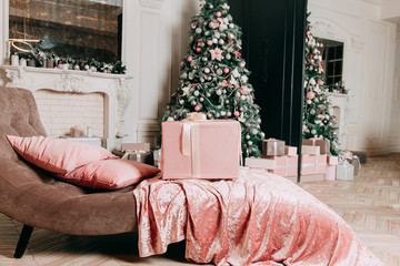 New Year's decor idea for a living room with gifts under a Christmas tree.