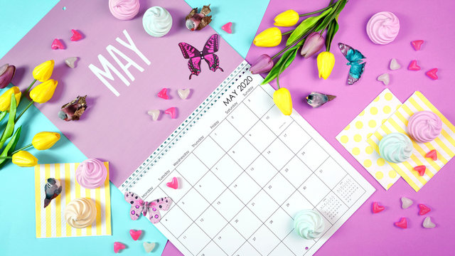 On-trend 2020 calendar page for the month of May modern flat lay with seasonal food, candy and colorful decorations in popular pastel colors. One of a series for 12 months of the year.