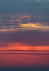 Fantastic clouds at sunrise, vertical panorama