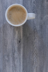 Coffee cup top view on grey wood table with copy space