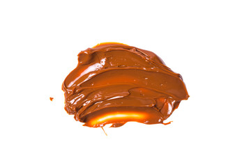 Melted tasty caramel splashes isolated on white background.