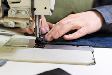 professional production sewing machine close-up, leather production, hand seamstress, hand tailor
