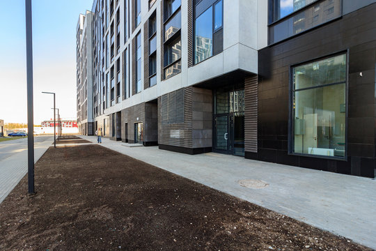 Exterior Ground floor under construction. decoration with bare walls, large panoramic French window. Concept repair, housewarming, building. pavement, footpath footway. first floor