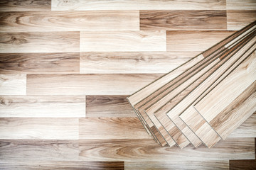 Laminated floor boards pile top view. Wooden floors work in new modern house.