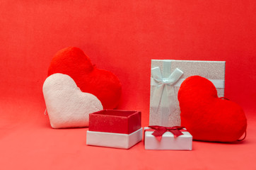 Valentine's day background with red and pink hearts, gift boxes on red background.