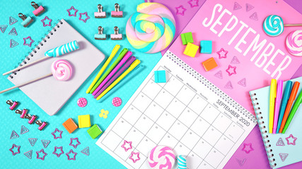 On-trend 2020 calendar page for the month of September modern flat lay with seasonal food, candy and colorful decorations in popular pastel colors. One of a series for 12 months of the year.