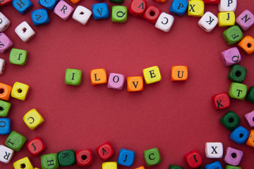 I LOVE you word, lettering on red background. Valentine's Day, friendship, mother's Day. Colorful blocks love word.