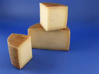 Cured Manchego cheese, derived from sheep's milk.