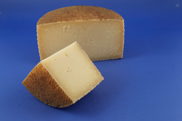 Cured Manchego cheese, derived from sheep's milk.