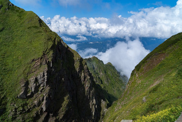 tops of green mountains in the clouds, scenic views high in the mountains