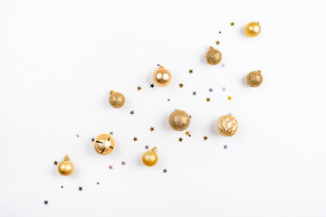 Festive white background with gold Christmas decorations. Flat lay, top view.
