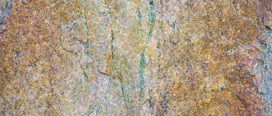 Granite texture. Granite rocks with porous surface. Background from solid stone. Pattern with natural material. Widescreen