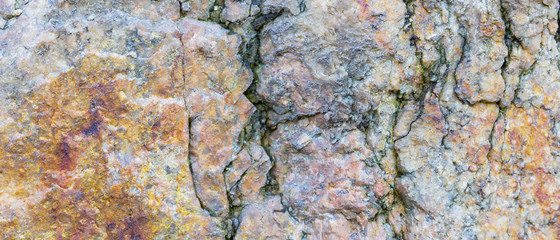 Granite texture. Granite rocks with porous surface. Background from solid stone. Pattern with natural material. Widescreen