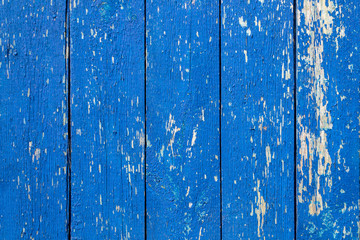 background wooden old fence made of boards, blue, shabby paint, aged texture