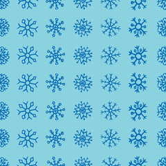 Seamless background of hand drawn snowflakes