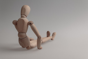 human figurine depicting a lonely bored person, the concept of abandonment and uselessness, despair...