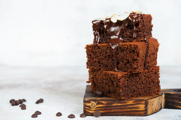 Delicious brownie chocolate cakes poured with warm chocolate and decorated with almond petals. Horizontal orientation with copy space