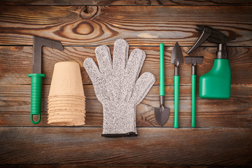Gardening tools on wooden background flat lay top view