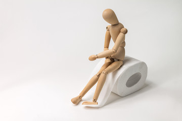 figure of a man sitting on a roll of toilet paper holding his stomach, diarrhea, abdominal pain,...