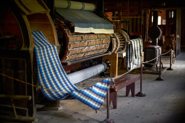colored woolen threads on an old loom, Traditional Yarn in Canada.