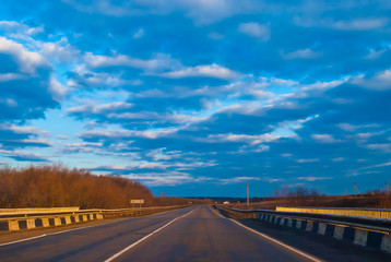 Road under the evening blue sky