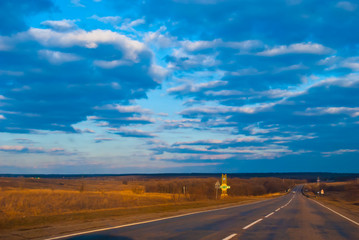 Obraz na płótnie Canvas Road under the evening blue sky