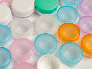 containers for soft contact lenses, multi-coloured, plastic, for cleaning and storage, close up