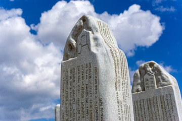 historic inscribed stone and cloudy sky