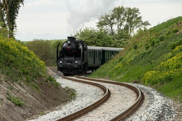 A steam passenger train arrives