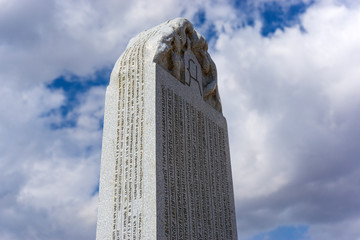historic inscribed stone and cloudy sky