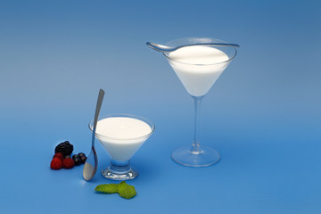 Tubs of natural yogurt, derived from cow's milk.