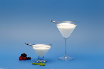 Tubs of natural yogurt, derived from cow's milk.