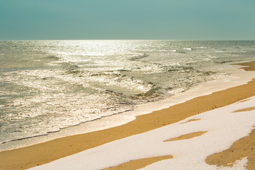 Snow and water on the beach