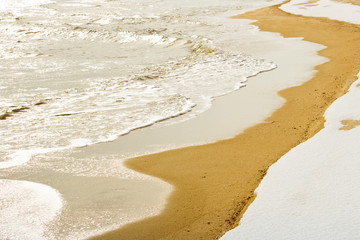Snow and water on the beach