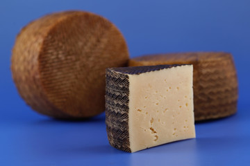 Cured Manchego cheese, derived from sheep's milk.
