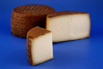 Cured Manchego cheese, derived from sheep's milk.