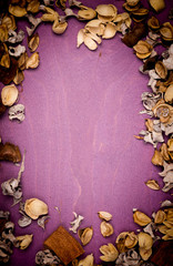  frame with flower petals on a wooden background