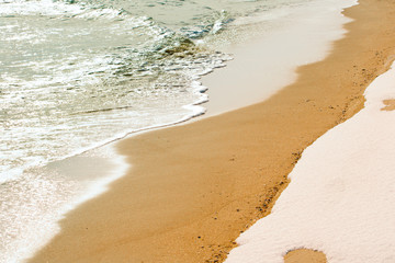 Snow and water on the beach