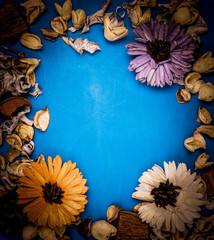  frame with flower petals on a wooden background